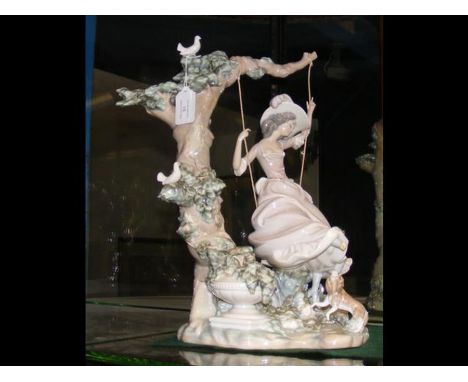 A large Lladro figure of girl on swing with doves in tree - 43cms highCONDITION REPORTBy our judgement, condition of lot is f