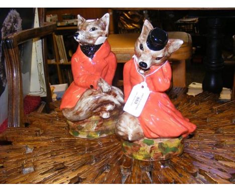 Two ceramic figures depicting foxes 
