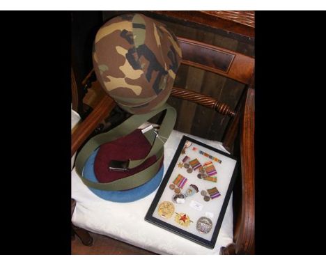 A selection of First and Second World War miniatures, Russian badges, together with berets and helmet