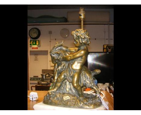 A table lamp in the form of a bronzed statuette of cherub and goat on marble base 