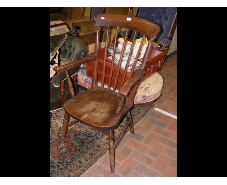 An antique stick back country armchair