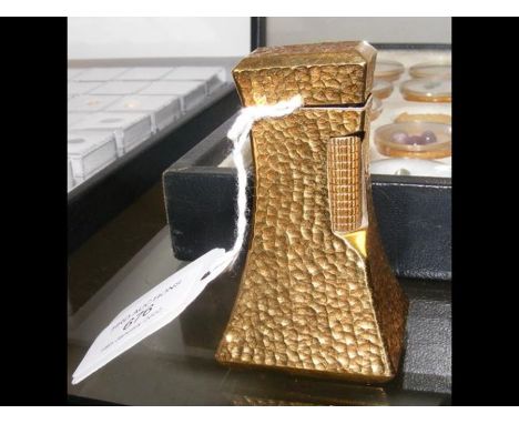 A Dunhill gold plated 'lighthouse' cigarette lighter with hammered finish