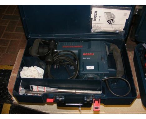 A Bosch electric hammer tool with case and instruction manual