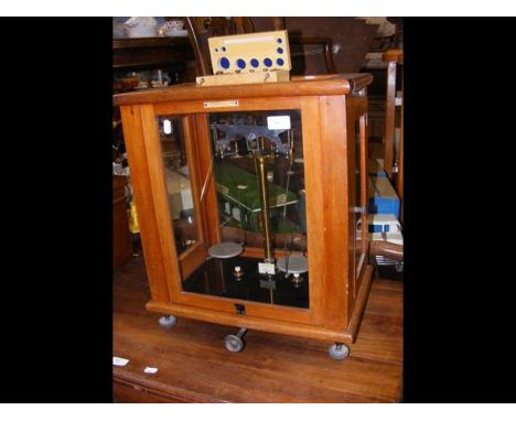 A cased set of laboratory scales with weights CONDITION REPORTbase is 35cm x s0cm and 40cm high