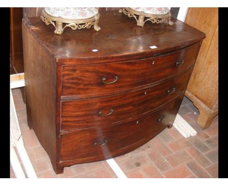 A bow front chest of three long drawers 