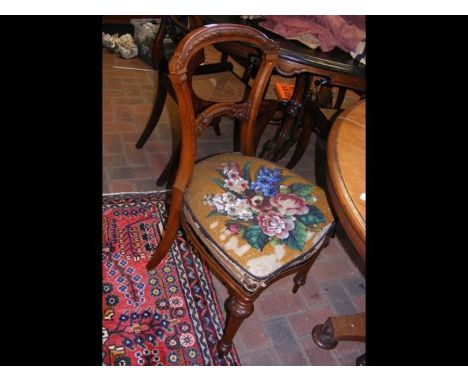 A set of four Victorian walnut dining chairs with tapestry seats