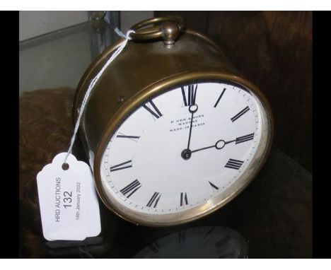 A circular French bedside clock with enamel face - 9.5cm diameter