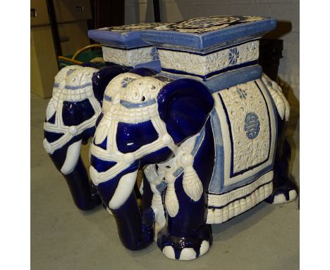 A pair of ceramic elephant garden seats, 44cm high and a pair of modern cloisonné bowls with lids, on wooden stands. 