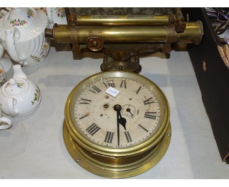 A ship's brass bulkhead clock, 24cm and a brass theodolite by J Hadden &amp; Co, Manchester and London, (2). 