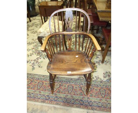 A 19th century yew wood comb-back Windsor armchair on turned legs, (a/f). 