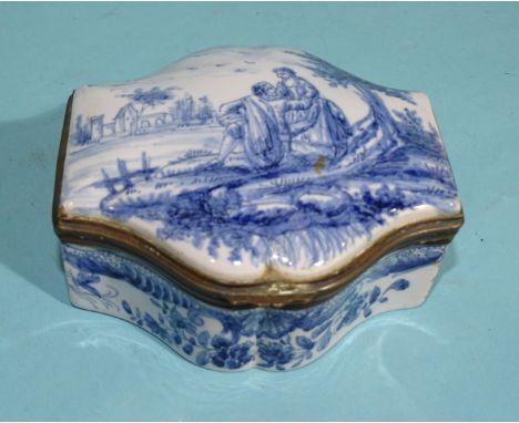 A Continental ceramic trinket box of shaped form, the lid with blue and white decoration of a courting couple within landscap