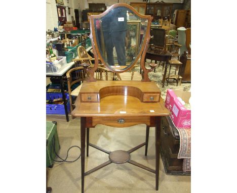 An Edwardian gentleman's mahogany shaving stand, the superstructure fitted with a shield-shaped mirror and two small drawers 