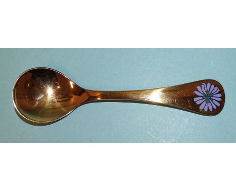 A silver gilt 1980 spoon with enamel flower, maker's mark RA AB, Georg Jensen, 42.9g.