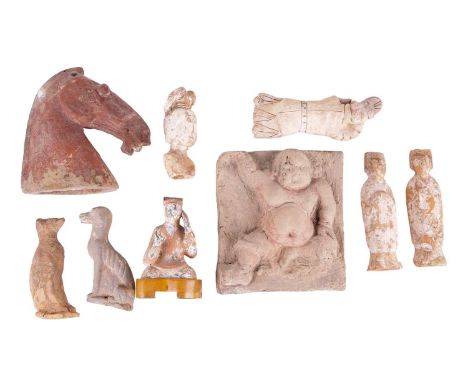A Chinese Yuan Dynasty terracotta square tile moulded in deep relief with a corpulent male figure with traces of the original