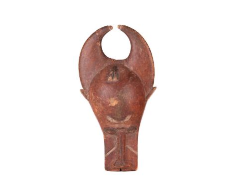 A Baule people wooden helmet animal mask (Bo Nun Amuin) with curved horns and signs of polychromic painting, 30 cm wide x 52 