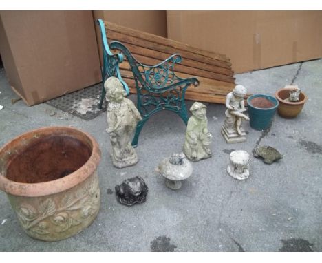 A CAST GARDEN BENCH A/F TOGETHER WITH A TERRACOTTA PLANTER AND CONCRETE GARDEN STATUES
