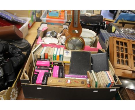 A TRAY OF ASSORTED BOOKS, INK CARTRIDGES, A BAROMETER ETC