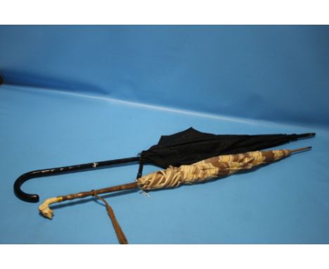 TWO PARASOLS TO INCLUDE A CARVED DOG'S HEADCondition Report:Both have general wear to the handles and canopy from use.  The b
