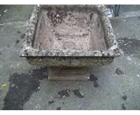 A RECONSTITUTED STONE GARDEN URN PLANTER