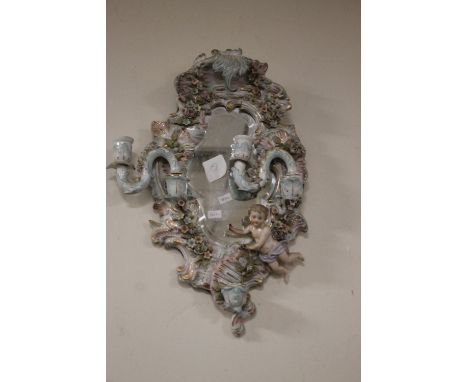 A DECORATIVE CERAMIC FRAMED MIRROR¦WIDTH: 25 CM¦LENGTH: 48 CMCondition Report: A crack to the top of the ceramic frame. Also 