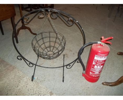 A DECORATIVE WROUGHT IRON GARDEN SWING PLANTER