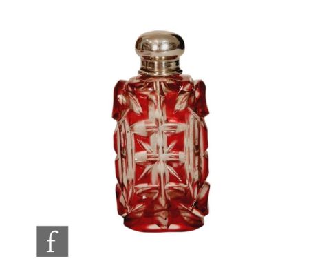 An early 20th Century scent bottle, the ruby flash cut shouldered rectangular bottle below a plain silver cap, height 8cm, un