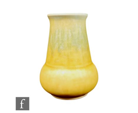 A small Ruskin Pottery crystalline glaze vase of globe and shaft form decorated with a tonal yellow glaze to the exterior and