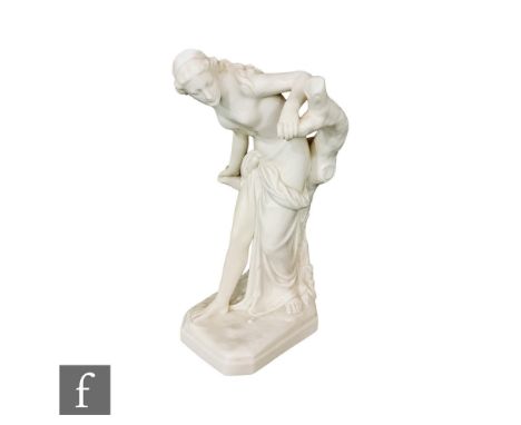 A Royal Worcester figure of the Bather Surprised, after the original by Sir Thomas Brock, modelled as a scantily clad maiden 