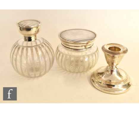 A hallmarked silver topped clear glass globular scent bottle with engine turned decoration, with a matched dressing table jar