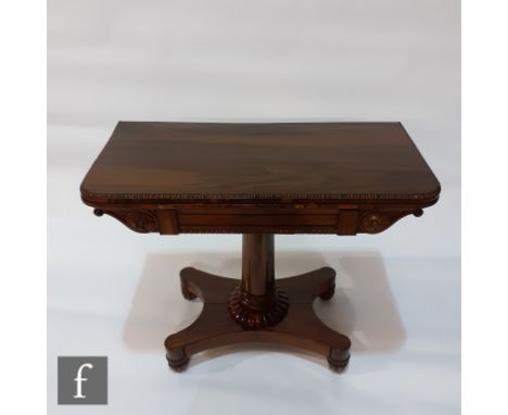A William IV rosewood fold-over card table, the rectangular top with a beaded border above rosette carved capitals to the apr