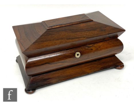 A 19th Century rosewood tea caddy of cushion shaped form, the top opening to reveal a mixing bowl and two separate canisters,