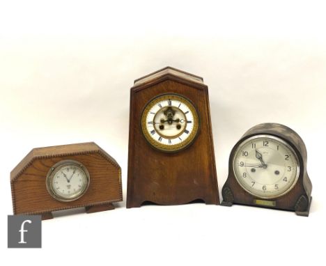 A Smiths car clock No 122459 in later oak case, another Smiths clock and an oak cased mantle clock. (3) 