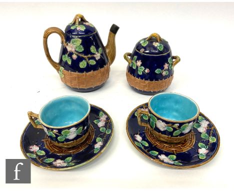 A 19th Century George Jones majolica tea for two comprising teapot, sugar box and cover and a two teacups and saucers, each d