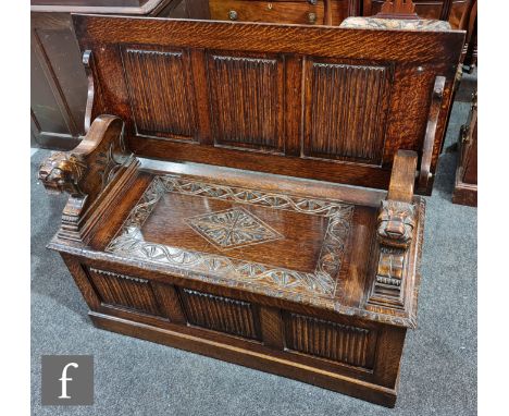 A Victorian carved oak monks bench, the panel lift top over a linen fold front, height 74cm x depth 46cm x width 107cm. 
