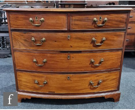 A George III mahogany bowfront chest of two short and three long drawers, brass drop handles below a moulded edge top, on bra