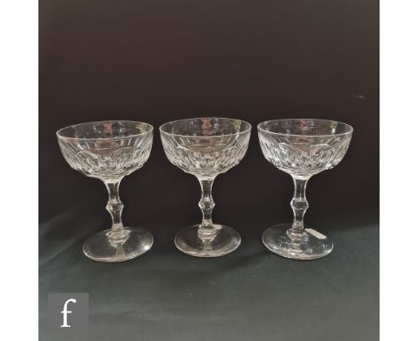 A set of twelve late 19th to early 20th Century clear crystal champagne coups or saucers, each with a repeat printie panel cu