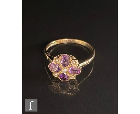 A 9ct hallmarked Edwardian style amethyst and seed pearl cluster ring, central pearl with four radiating amethysts spaced by 