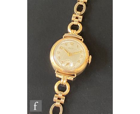 A 9ct hallmarked lady's Tissot wrist watch, Arabic numerals to a circular dial and a 9ct hallmarked bracelet, total weight 16