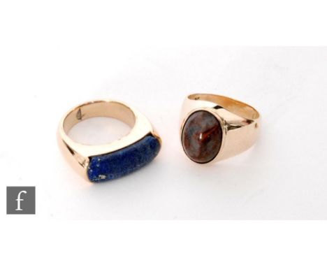 Two gentleman's stone set rings, an elongated lapis lazuli and an oval polished agate example, total weight 14g, ring sizes O