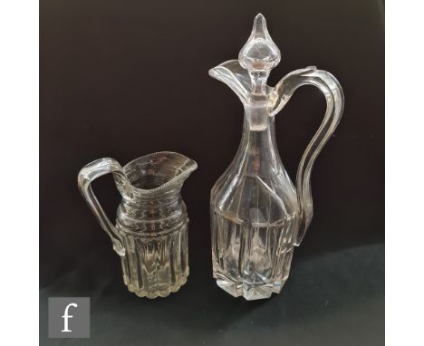 A 19th Century clear cut crystal claret jug with mitre cut panel body beneath a tapered neck with arcghed handle, later repla