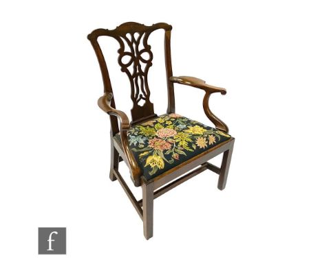 A 19th Century Chippendale style mahogany elbow chair, with a pierced vase splat below an undulating top rail over a tapestry