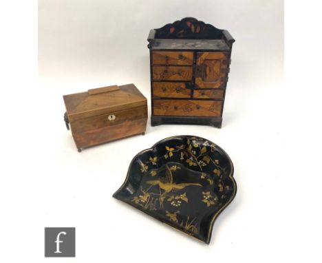 A 19th century mahogany tea caddy, a japanned lacquered crumb scoop and a Japanese trinket cabinet. (3) 