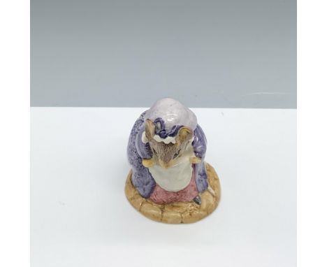 Glossy porcelain figure modeling a purple robe and a bonnet. Royal Albert Beatrix Potter backstamp. This item has its origina
