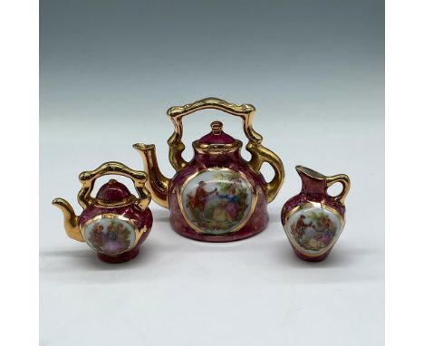 Crackle design over raspberry porcelain with gilt accents and hand painted portrait art. Set includes large teapot with cover