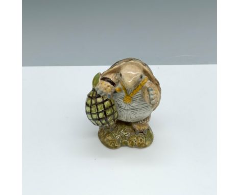Glossy porcelain figure of a turtle wearing a necklace and holding a bag. Royal Albert Beatrix Potter backstamp. This item ha