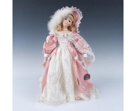 Collectible edition, handcrafted doll dressed in pink Victorian dress with matching hat, carrying a pouf bag. Doll comes with