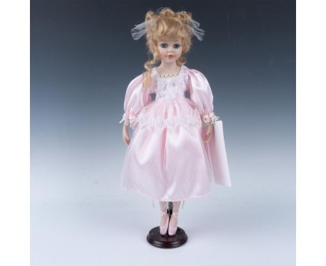 Hand crafted pretty ballerina dressed in pink satin dress with lace overlay and matching slippers. Metal stand is included. A