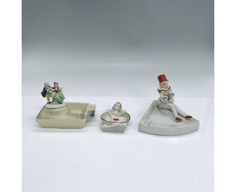 Three handpainted ashtrays featuring people: a couple, a lady in a hat playing a banjo and a reclining lady. The ashtray with