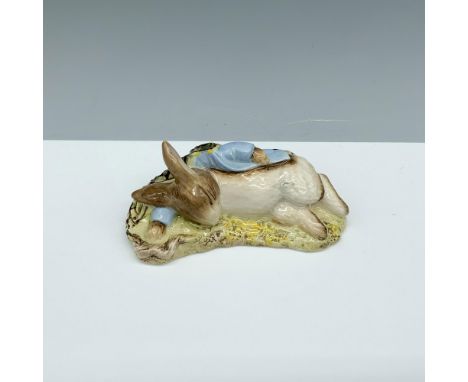 Glossy porcelain figure of a rabbit sleeping on the floor. Royal Albert Beatrix Potter backstamp. This item has its original 