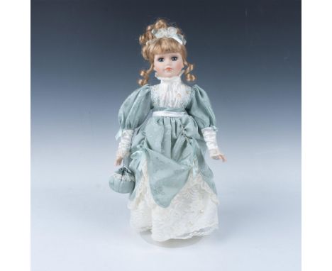 Lovely hand crafted and hand painted porcelain doll has blonde hair styled in hand sewn sage fabric with lace and bead accent